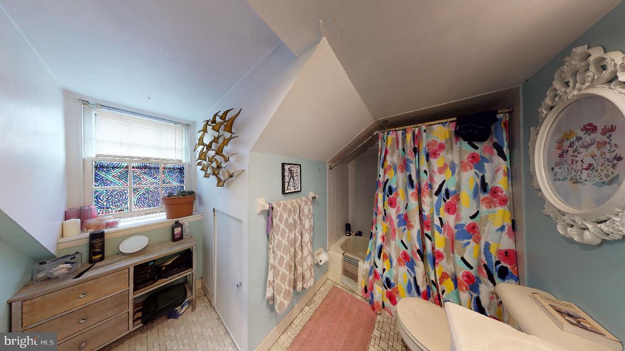 1018 Pine Street, Unit 3F Philadelphia, PA 19107 - Photo 9 of 10 a view of a bedroom with baby crib and a window