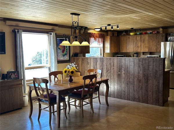 a dining room with furniture and window