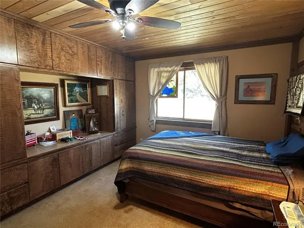 a room with pool table and windows