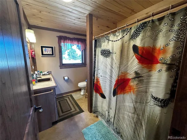 a bathroom with a toilet and shower