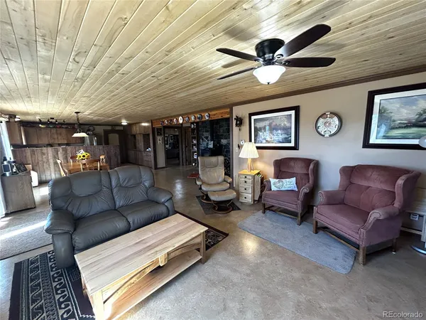 a living room with furniture and a ceiling fan