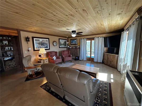 a living room with furniture window and a flat screen tv
