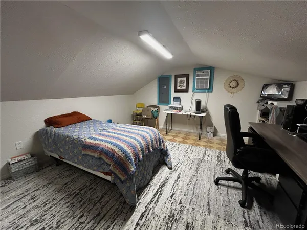 a bedroom with a bed and a chair