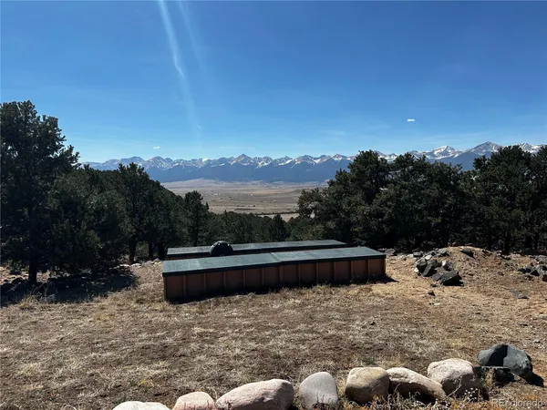 a view of swimming pool with mountain view and sitting area
