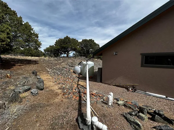 a backyard of a house with table and chairs