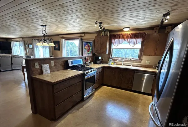 a kitchen with a stove a sink and a refrigerator