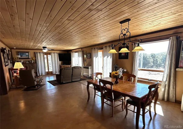 a view of a dining room with furniture window and outside view