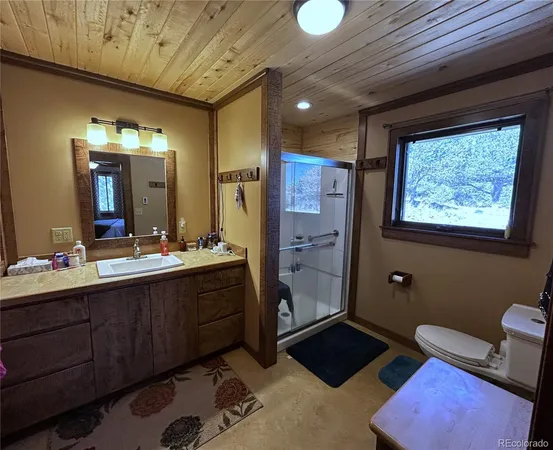 a spacious bathroom with a double vanity sink a mirror and a shower