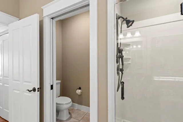 a bathroom with a granite countertop double vanity sink a mirror and a bathtub