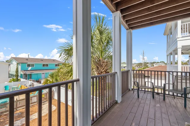 a view of a wooden balcony with plants