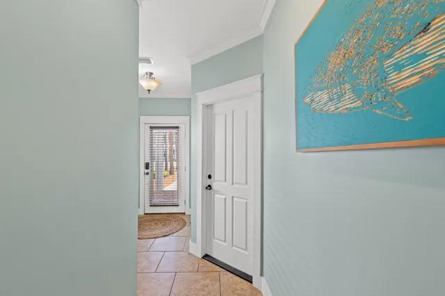 a bedroom with a bed wooden floor and window