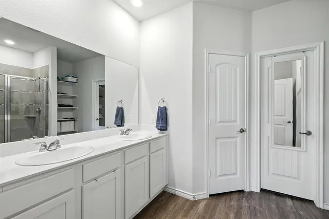 a bathroom with a glass shower door
