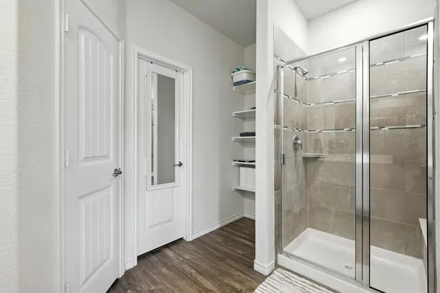 a bathroom with a glass shower door
