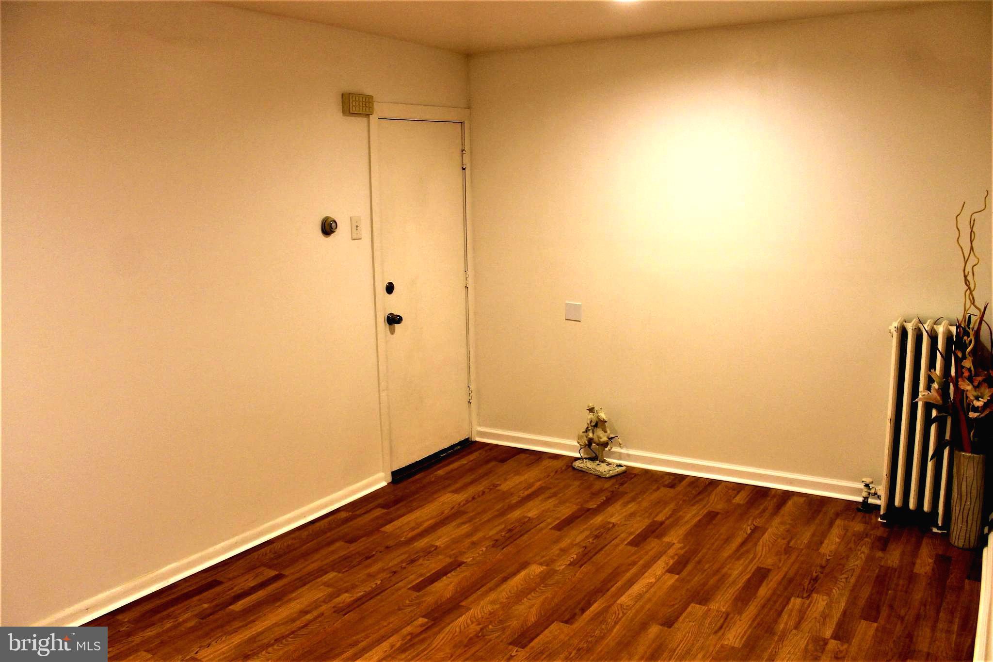 a view of a room with wooden floor and fence