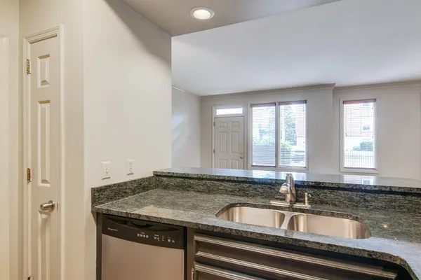 a kitchen with granite countertop a sink and a window