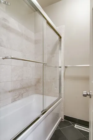 a bathroom with a bathtub and a shower