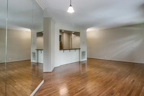 a view of an empty room and wooden floor