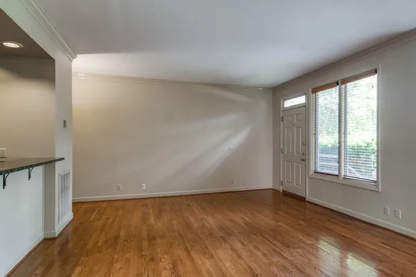 wooden floor in an empty room with a window