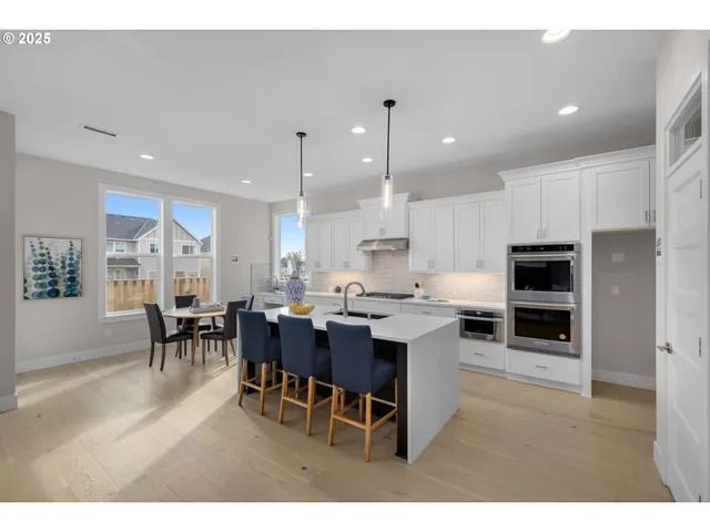 a kitchen with a table and chairs in it