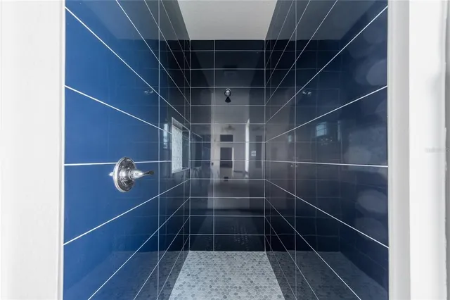 a white toilet sitting next to a white wall