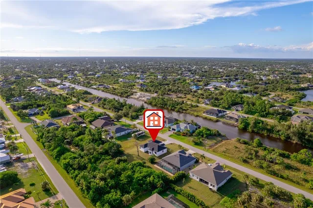 an aerial view of a house with a yard basket ball court and outdoor seating