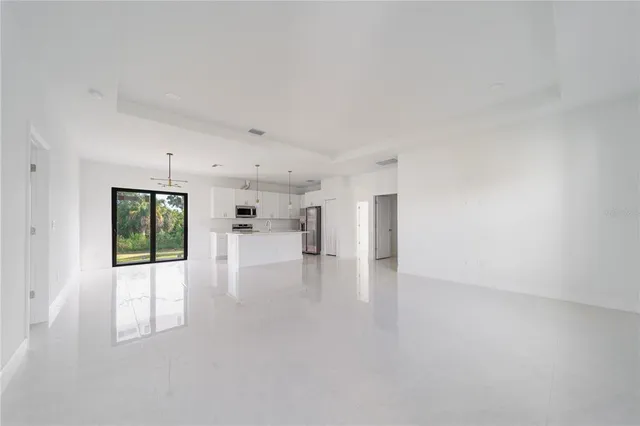 a open kitchen with cabinets and a refrigerator