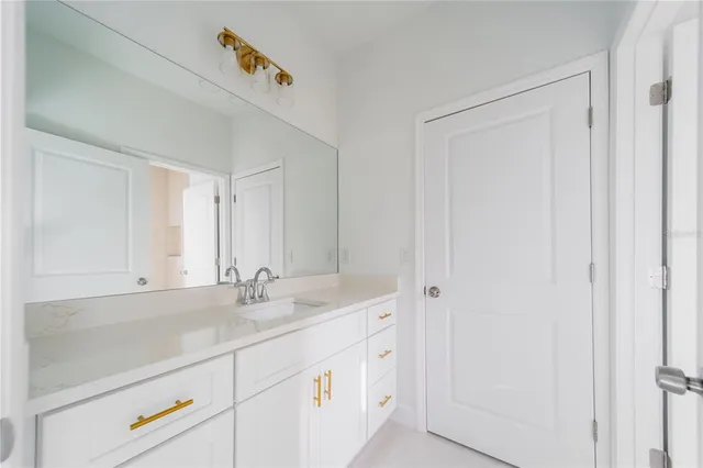 an empty room with a window and painting on the wall