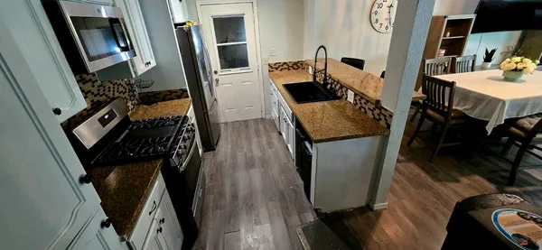 a view of a room with wooden floor