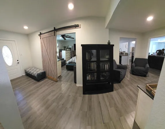 a view of a hallway with wooden floor and staircase