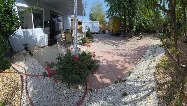 a view of a house with backyard and porch