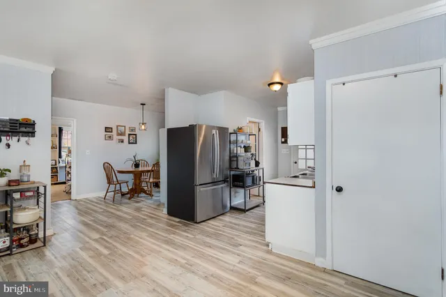 a kitchen with stainless steel appliances a refrigerator and a stove top oven