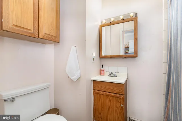 a bathroom with a sink a mirror and a toilet