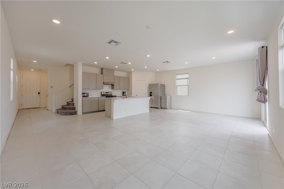 5927 Coja Street Las Vegas, NV 89113 - Photo 10 of 32 Unfurnished living room featuring recessed lighting, stairway, and light tile patterned flooring