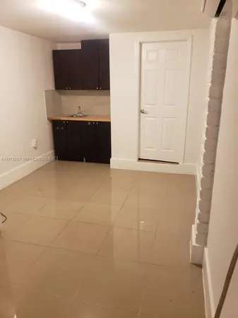 a view of room with microwave and refrigerator