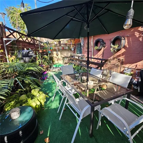 a patio with tables and chairs