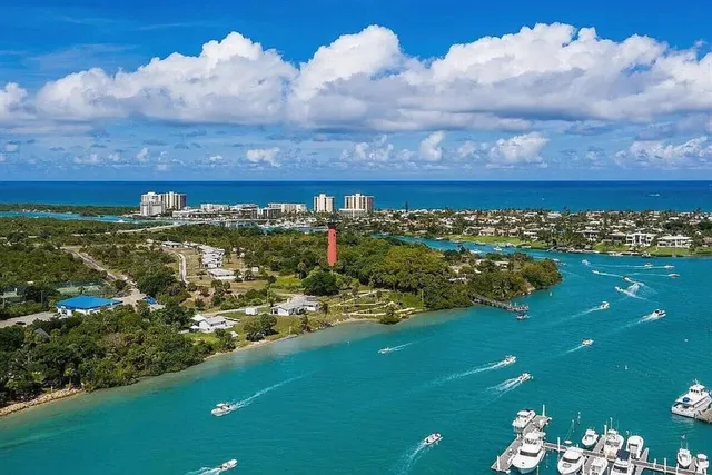 a view of a city with lots of residential buildings ocean and mountain view in back