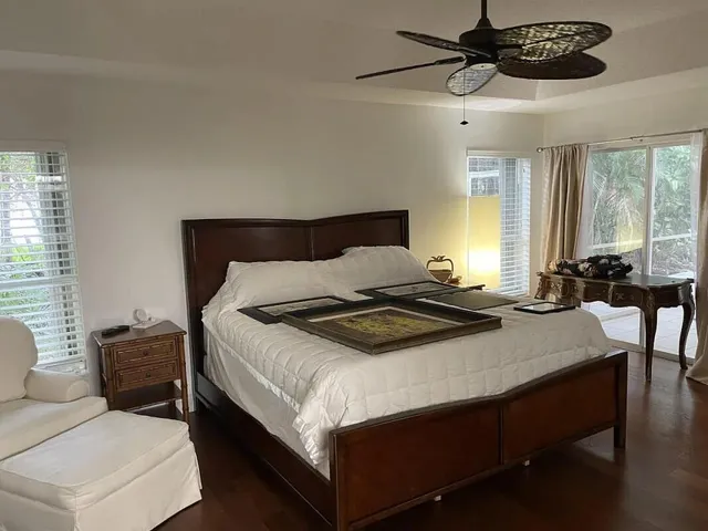 a bedroom with a bed a table and chair