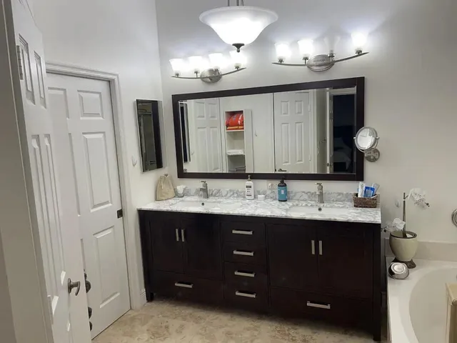 a bathroom with a double vanity sink and a mirror