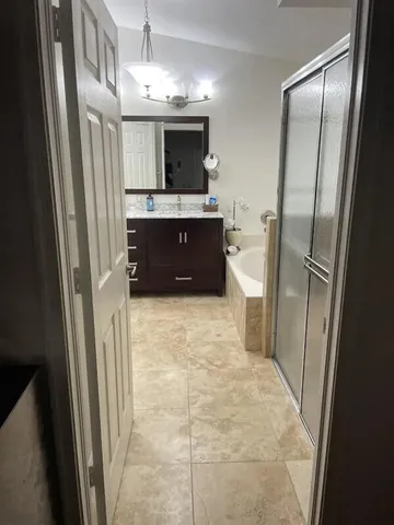 a bathroom with a sink a toilet a mirror and shower view