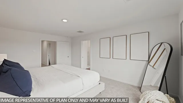 a large white bed in a white room