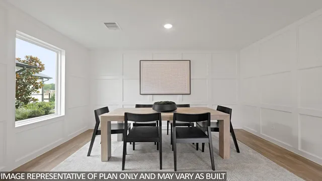 a view of a dining room with furniture and a window