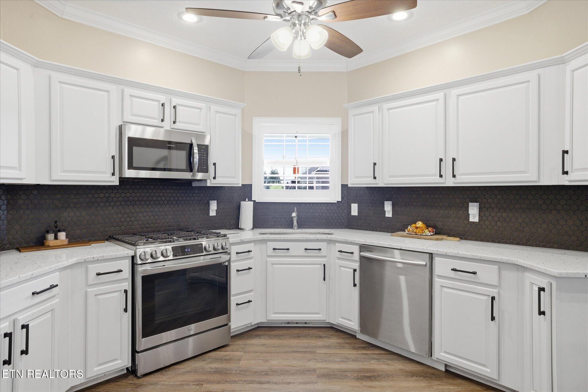 1330 Rippling Waters Circle Sevierville, TN 37876 - Photo 13 of 53 a kitchen with white cabinets white stainless steel appliances and sink