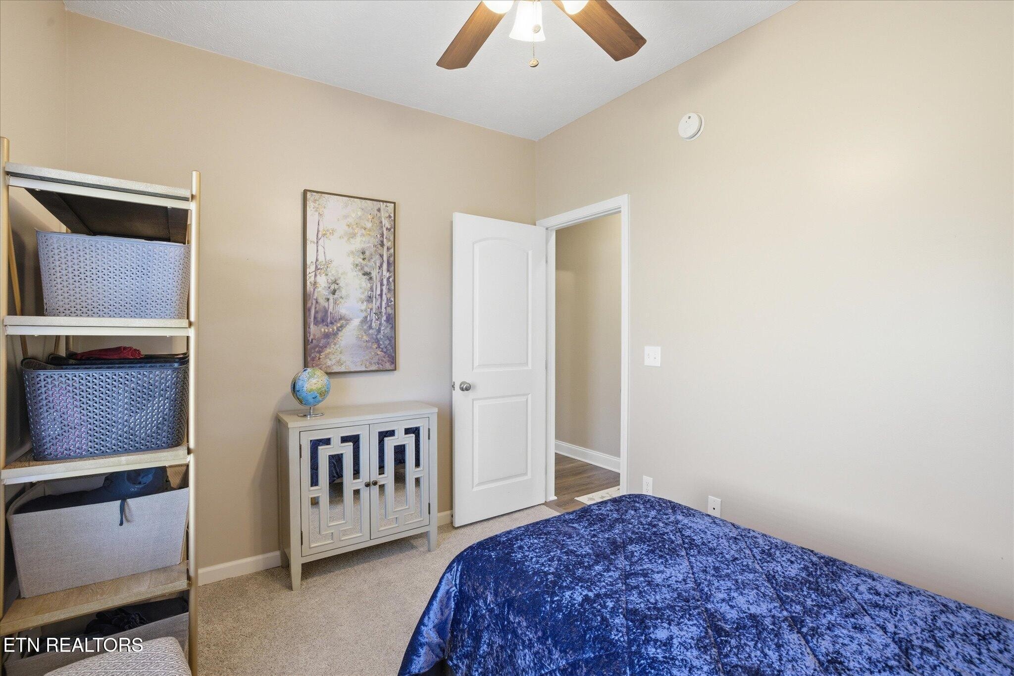1330 Rippling Waters Circle Sevierville, TN 37876 - Photo 33 of 53 a view of a hallway to a bedroom with wooden floor and chandelier