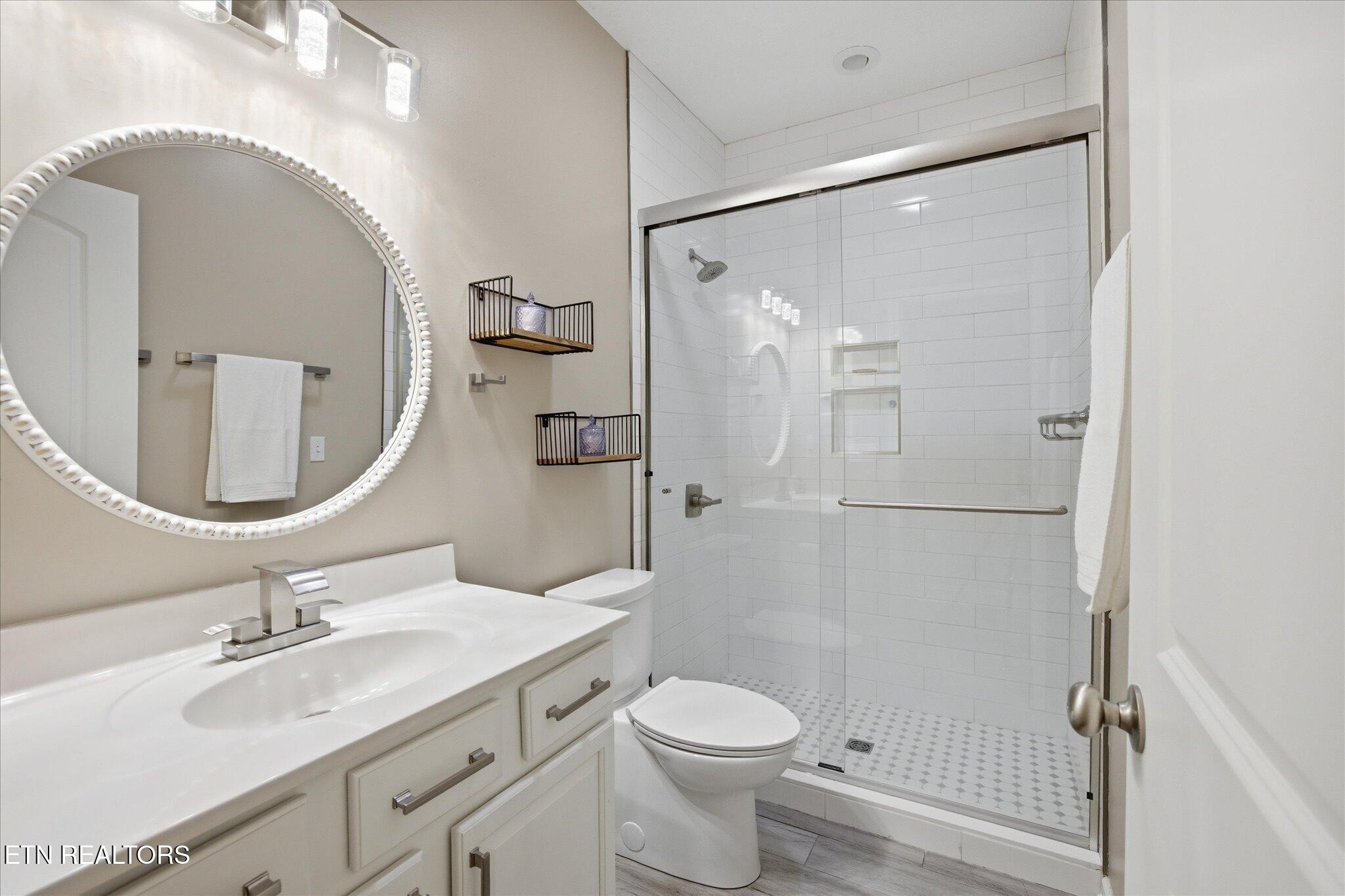 1330 Rippling Waters Circle Sevierville, TN 37876 - Photo 34 of 53 a bathroom with a granite countertop sink toilet and shower