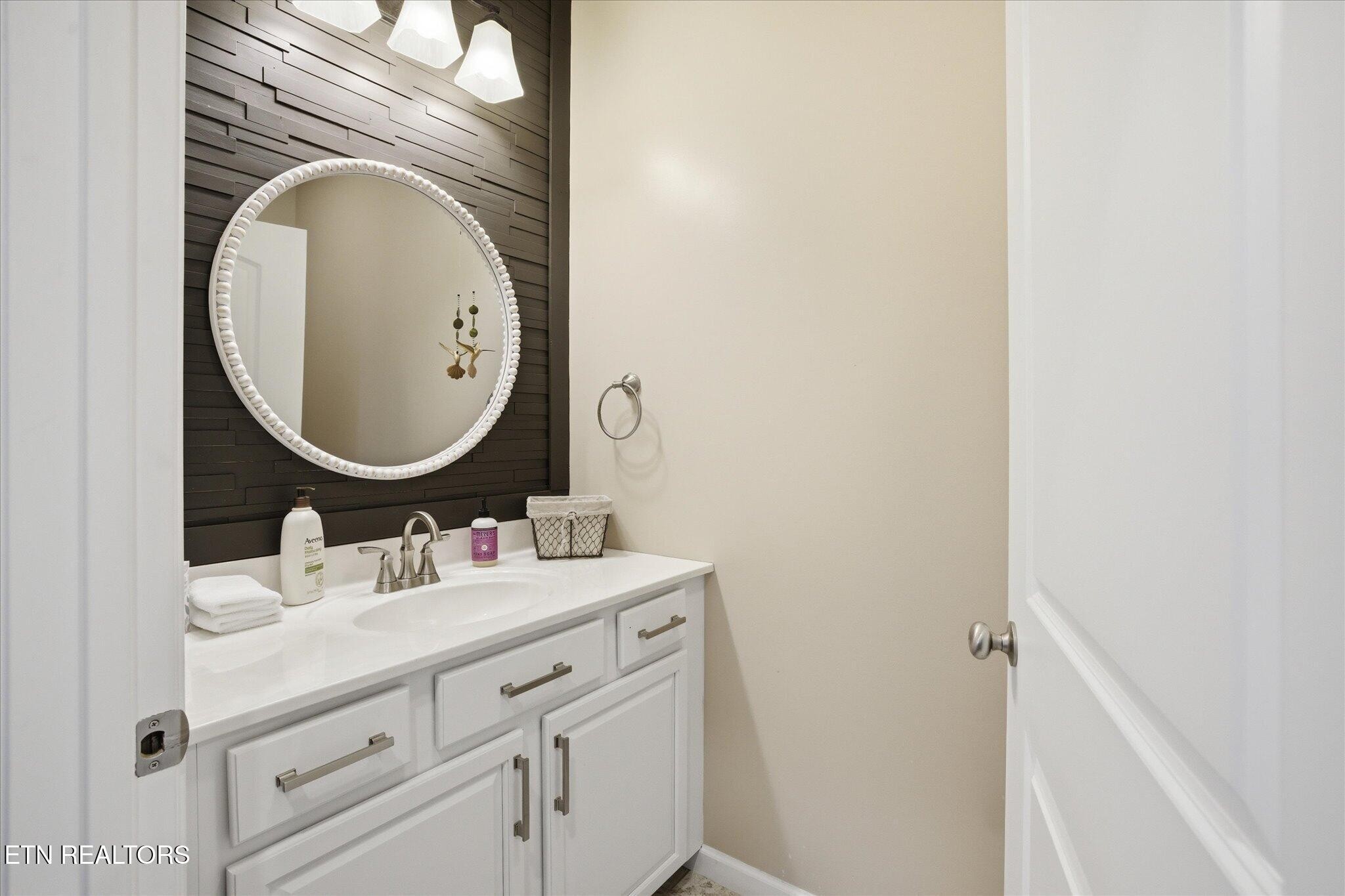 1330 Rippling Waters Circle Sevierville, TN 37876 - Photo 38 of 53 a bathroom with a sink and a mirror