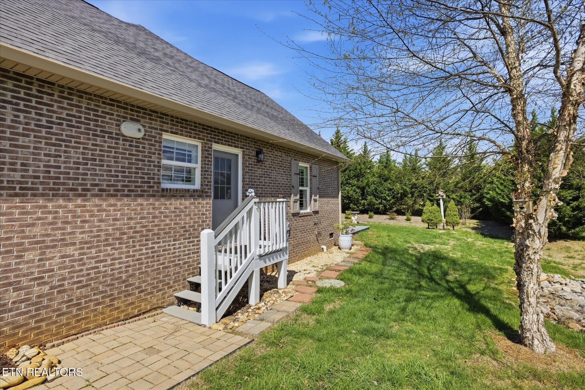 1330 Rippling Waters Circle Sevierville, TN 37876 - Photo 4 of 53 a backyard of a house with lots of green space