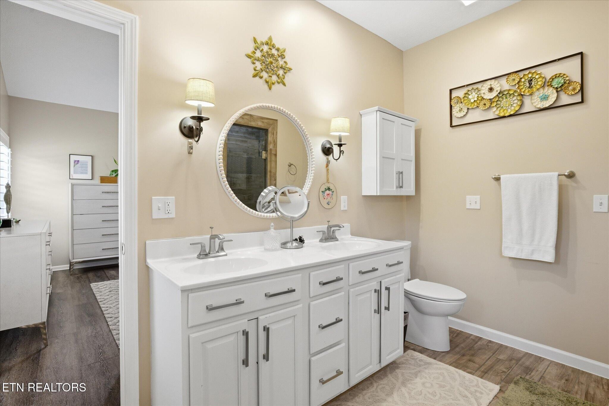 1330 Rippling Waters Circle Sevierville, TN 37876 - Photo 45 of 53 a bathroom with a toilet a sink and a mirror