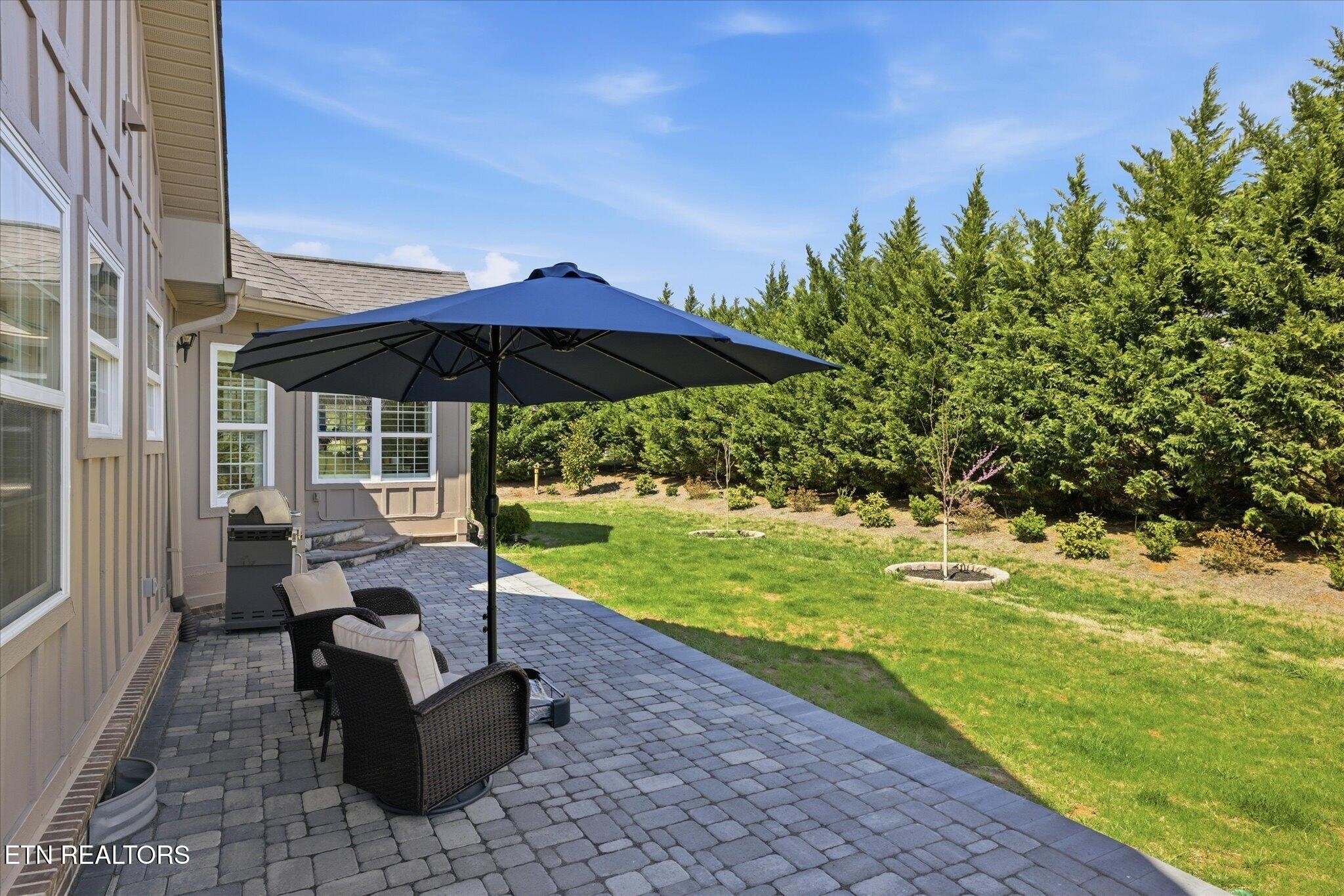 1330 Rippling Waters Circle Sevierville, TN 37876 - Photo 8 of 53 a patio with table and chairs under an umbrella