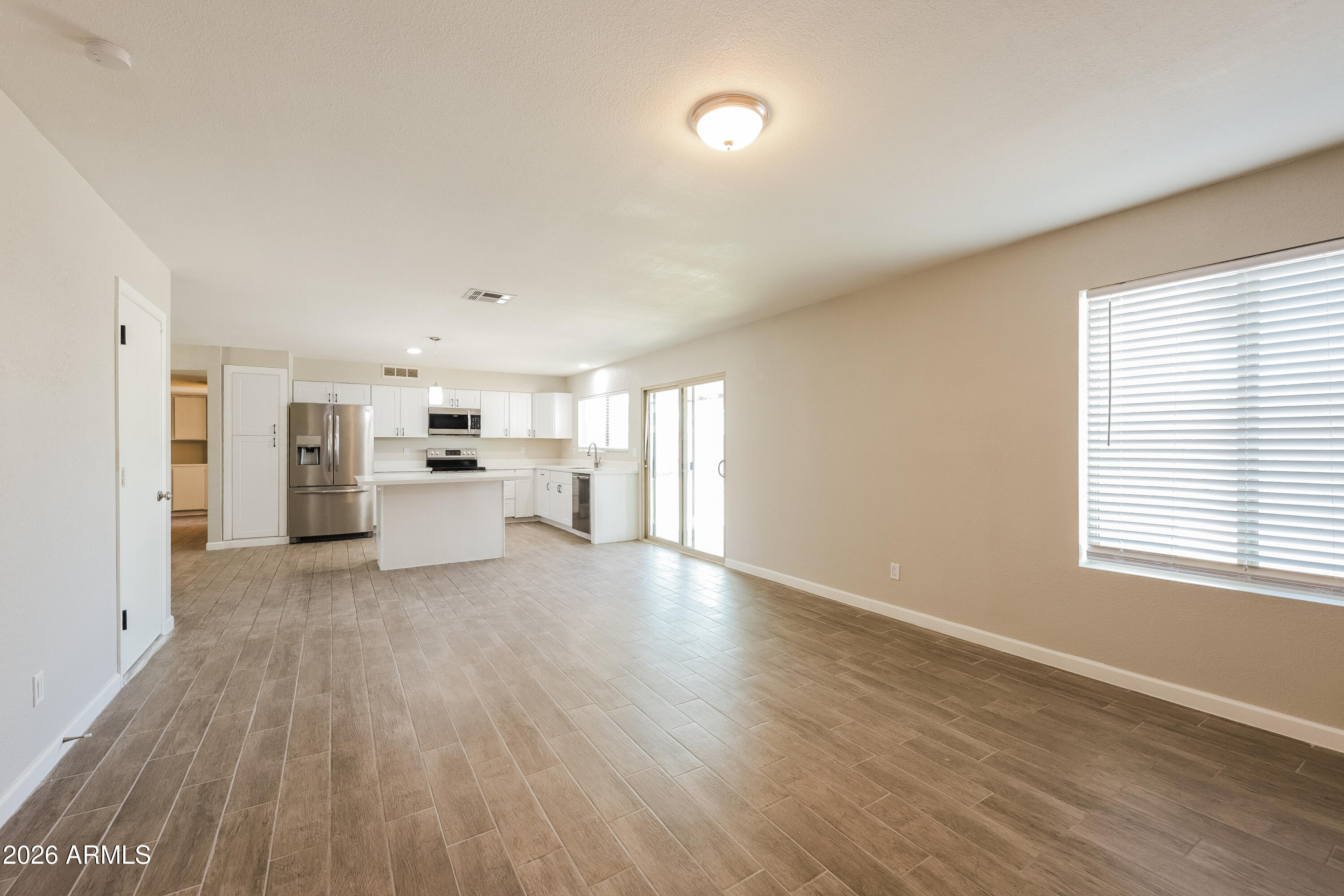 2501 East Villa Rita Drive Phoenix, AZ 85032 - Photo 9 of 15 a view of a kitchen with wooden floor electronic appliances and window
