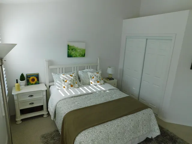 a spacious bedroom with a bed and a chandelier